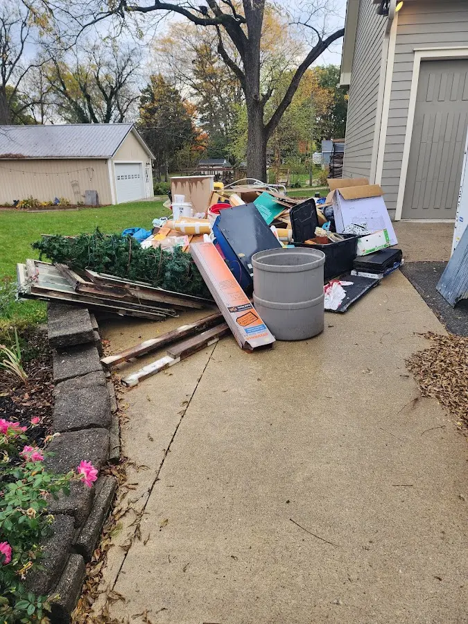 Dumpster being loaded with debris for Roofing Dumpster Rental in Oceola